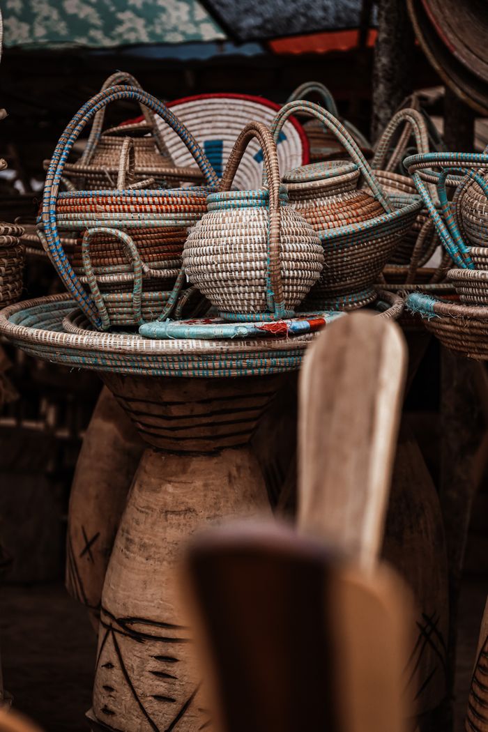 Colorful handwoven baskets displayed at a traditional market in Angola, showcasing local craftsmanship.