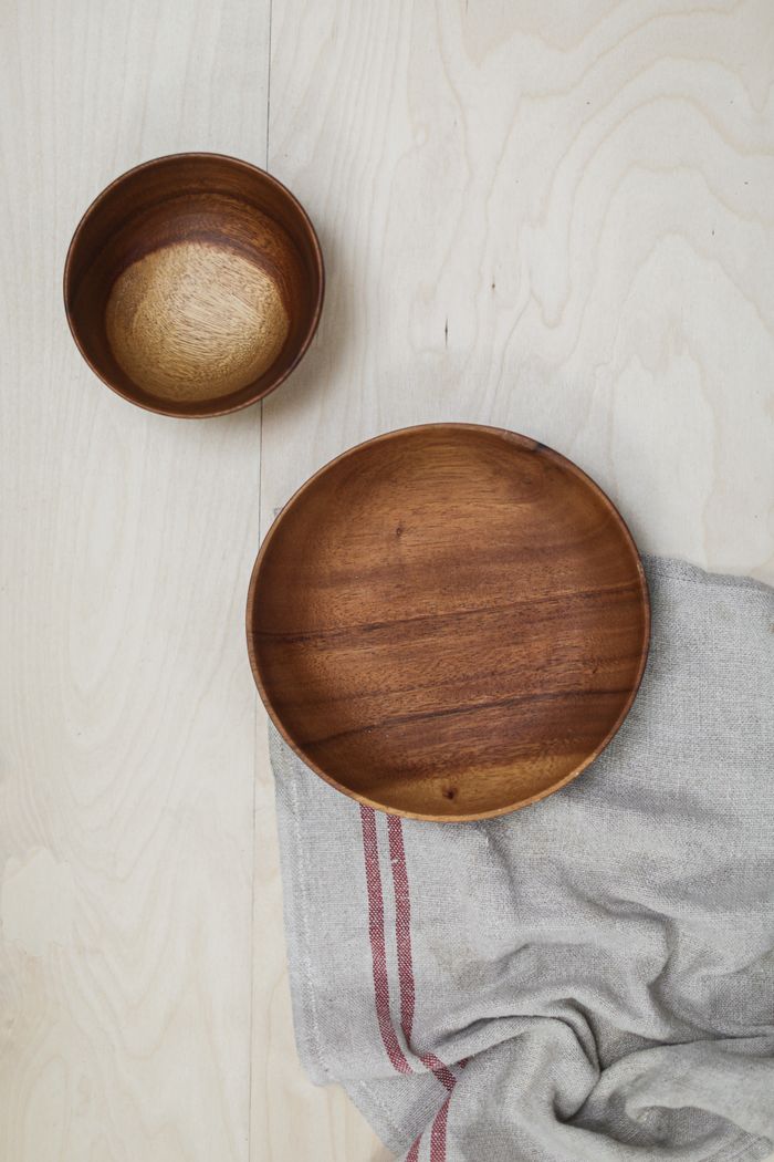 Top view of two wooden bowls on a light textile. Minimalist and natural theme.