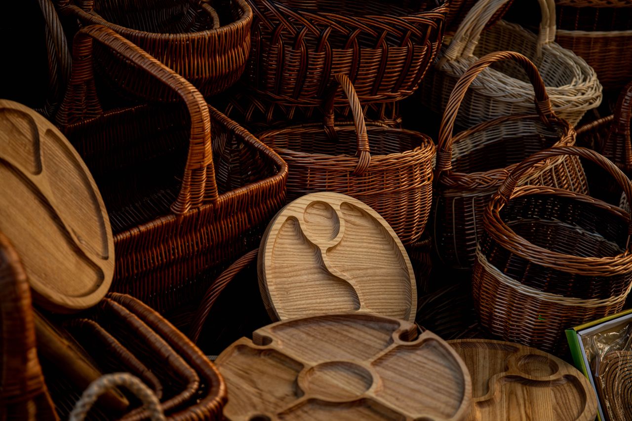 A collection of handcrafted wicker baskets and wooden trays showcasing rustic craftsmanship and design.